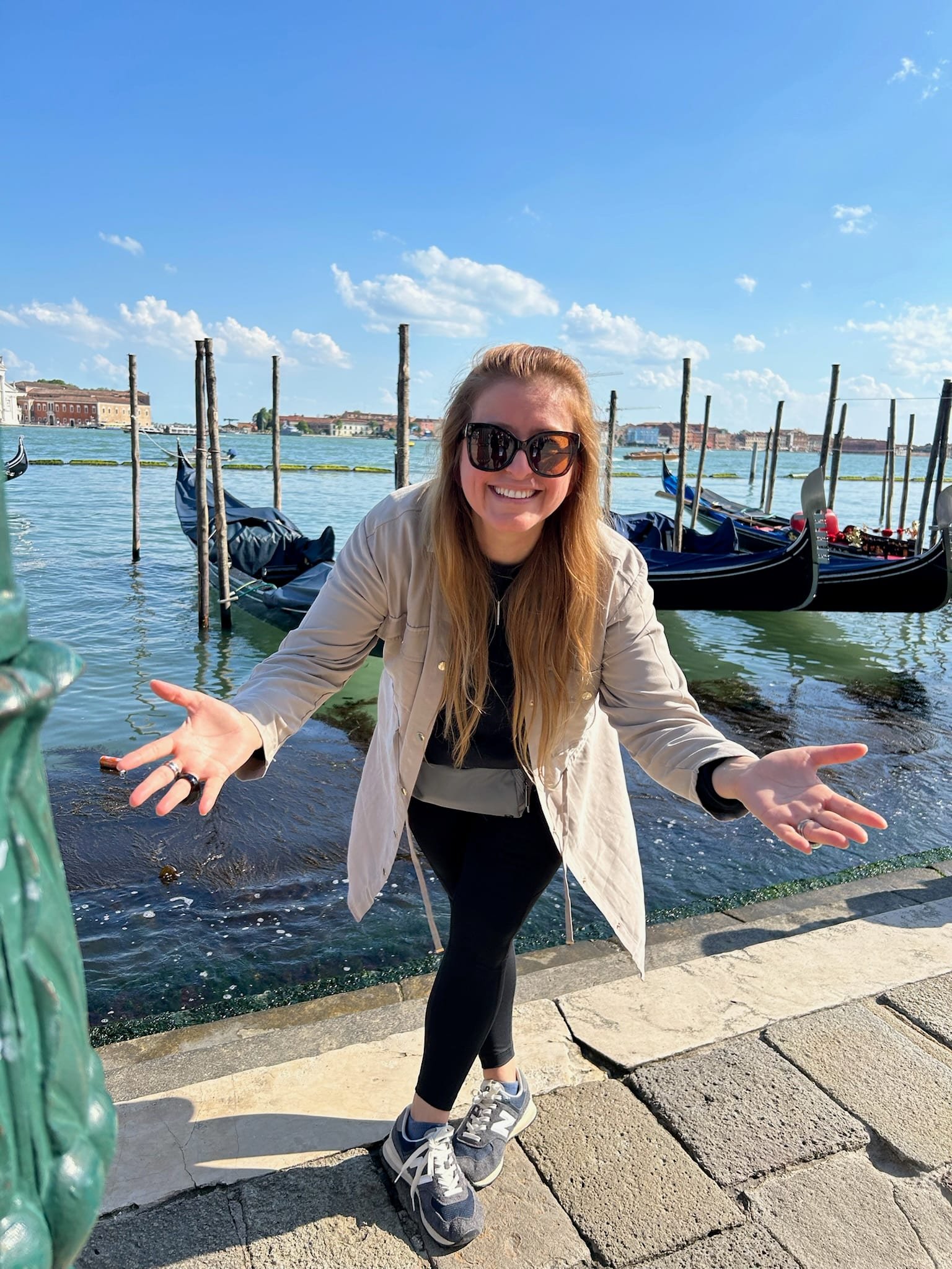 Ana beside gondolas on the Venetian lagoon